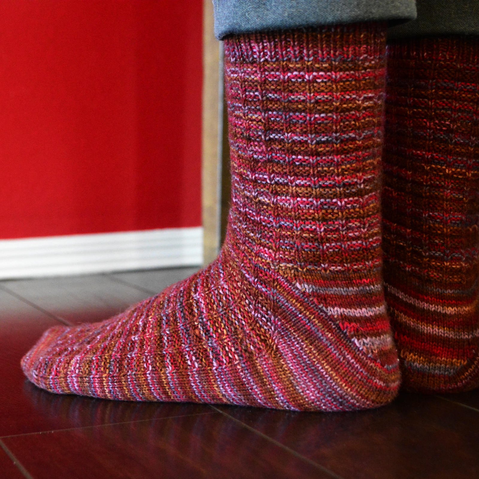 Closeup of short-row gusset heel of the waffle weave Adventure Socks knitting pattern on model's feet.