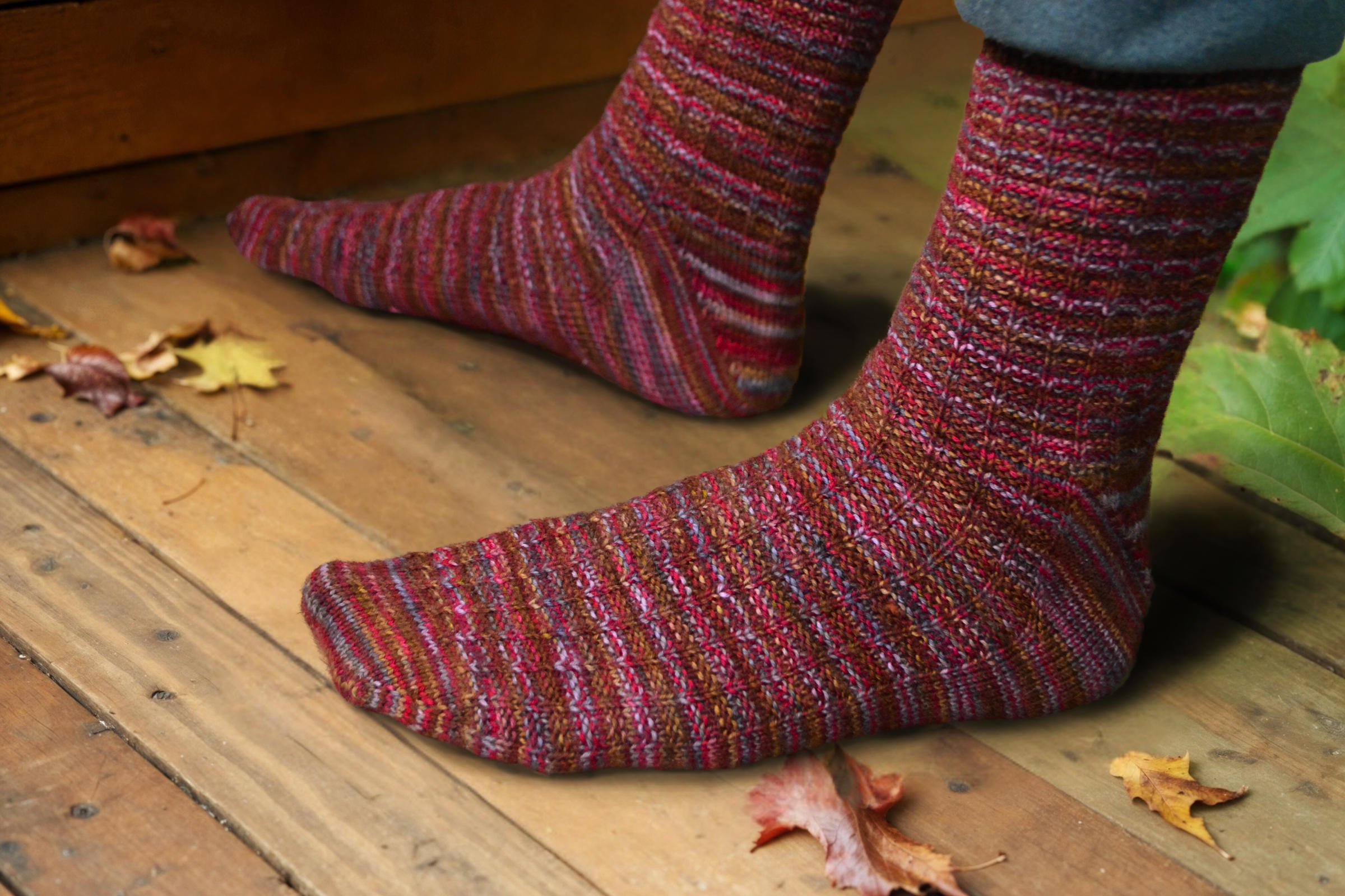 Closeup of top and side of the waffle weave unisex Adventure Socks knitting pattern, showing the raglan toe shaping, waffle weave texture, and short-row gusset heel.