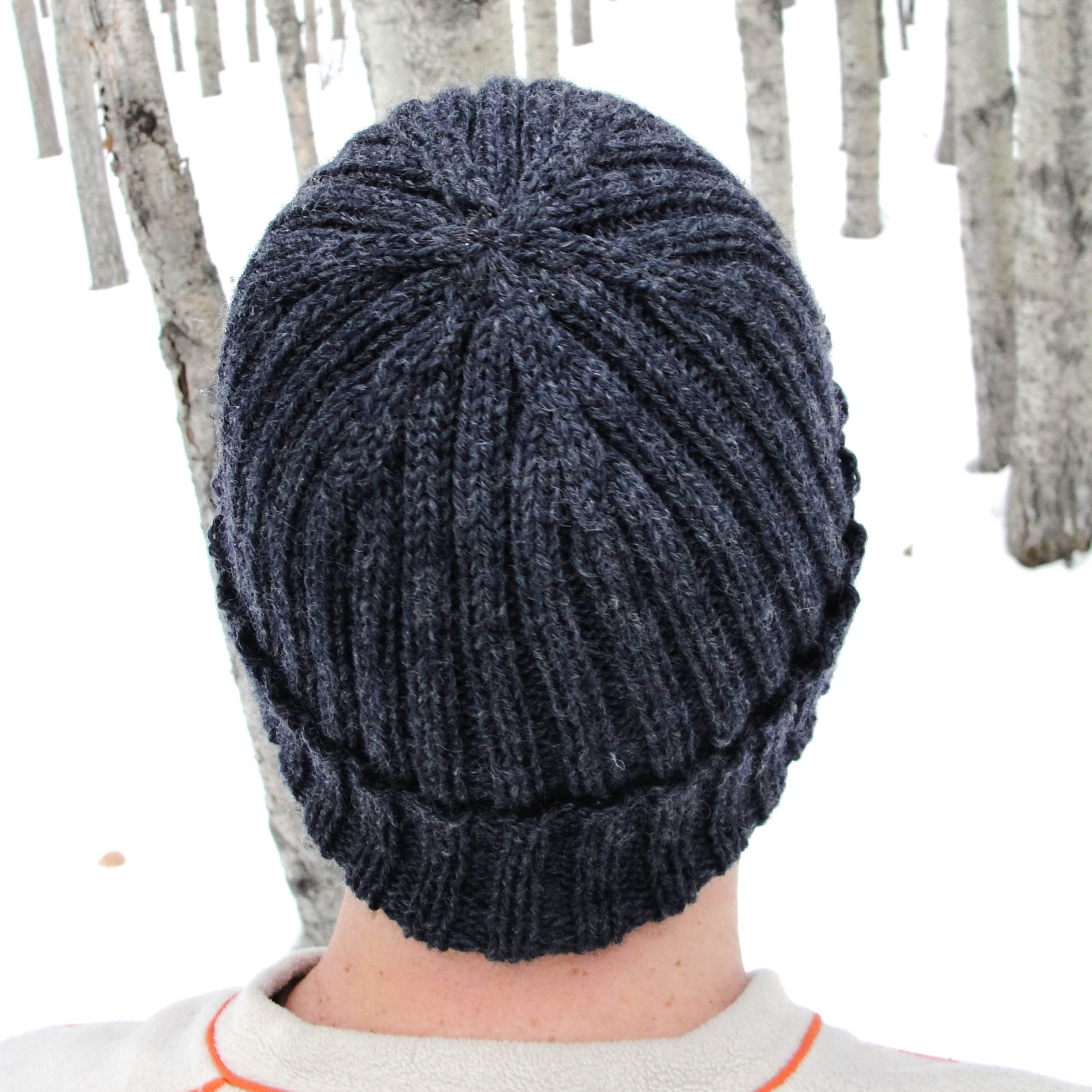 Crown of a ribbed beanie with a rolled brim showing raglan decreases in six places.