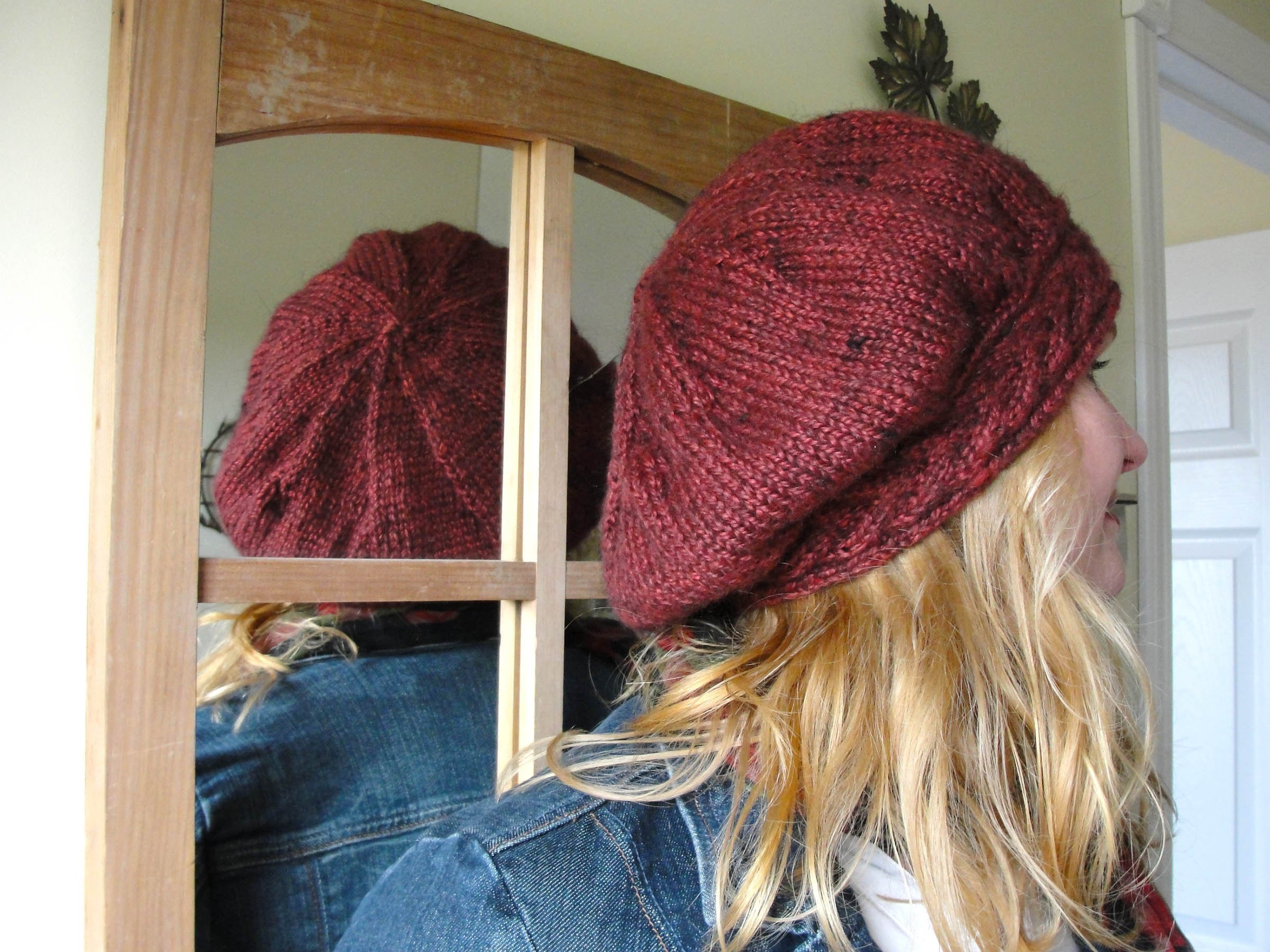 Profile and crown of a loose slouchy tam with a cabled hatband.
