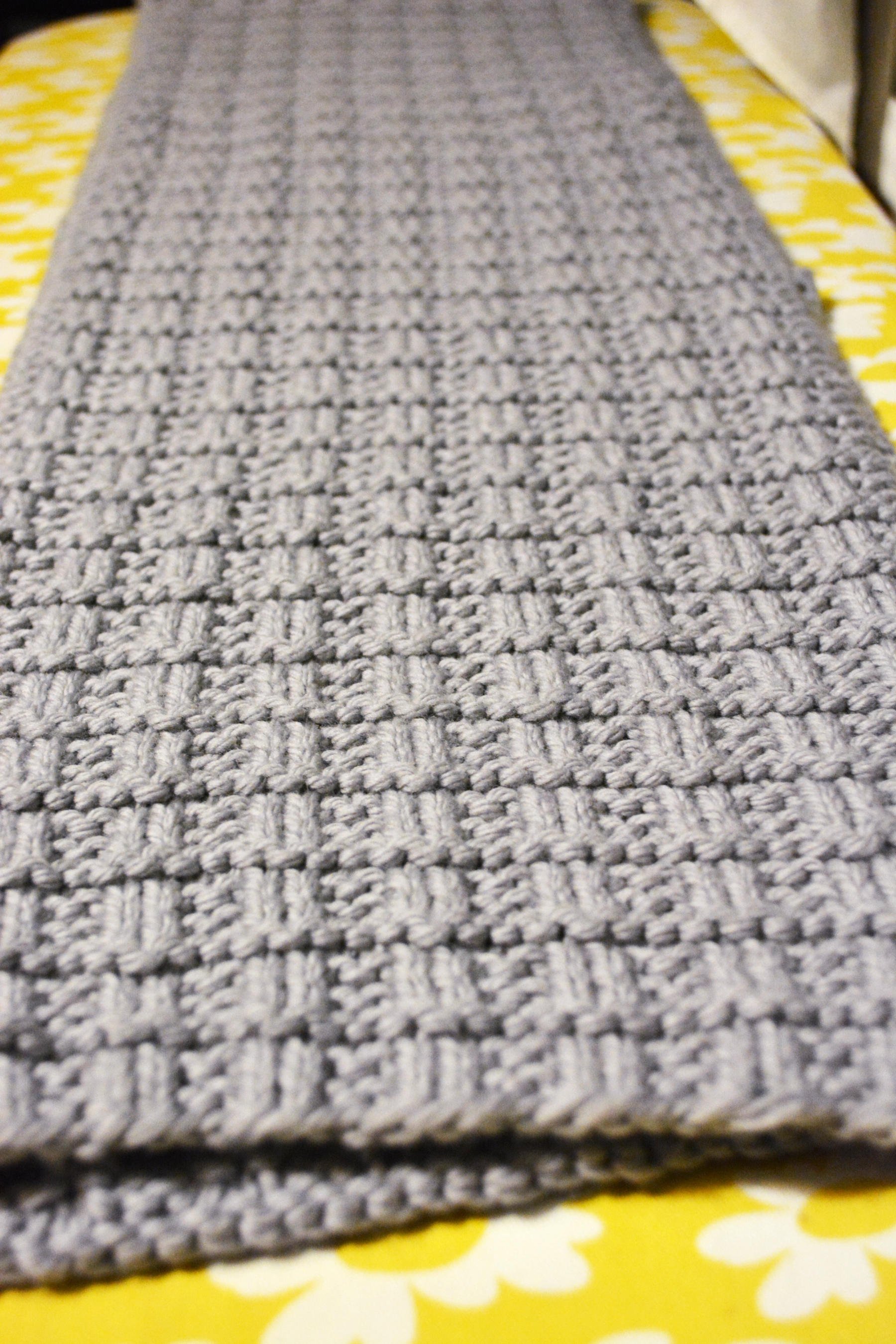 Close-up of a bulky-knit scarf with a waffle weave texture.